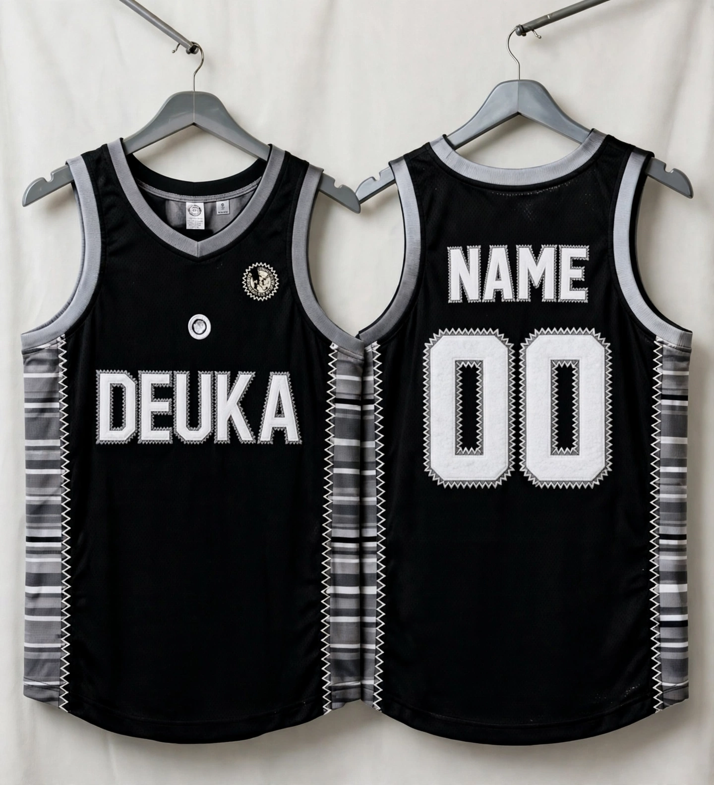 Black DEUKA basketball jerseys with striped side panels featuring tackle twill embroidery with zig-zag stitched borders