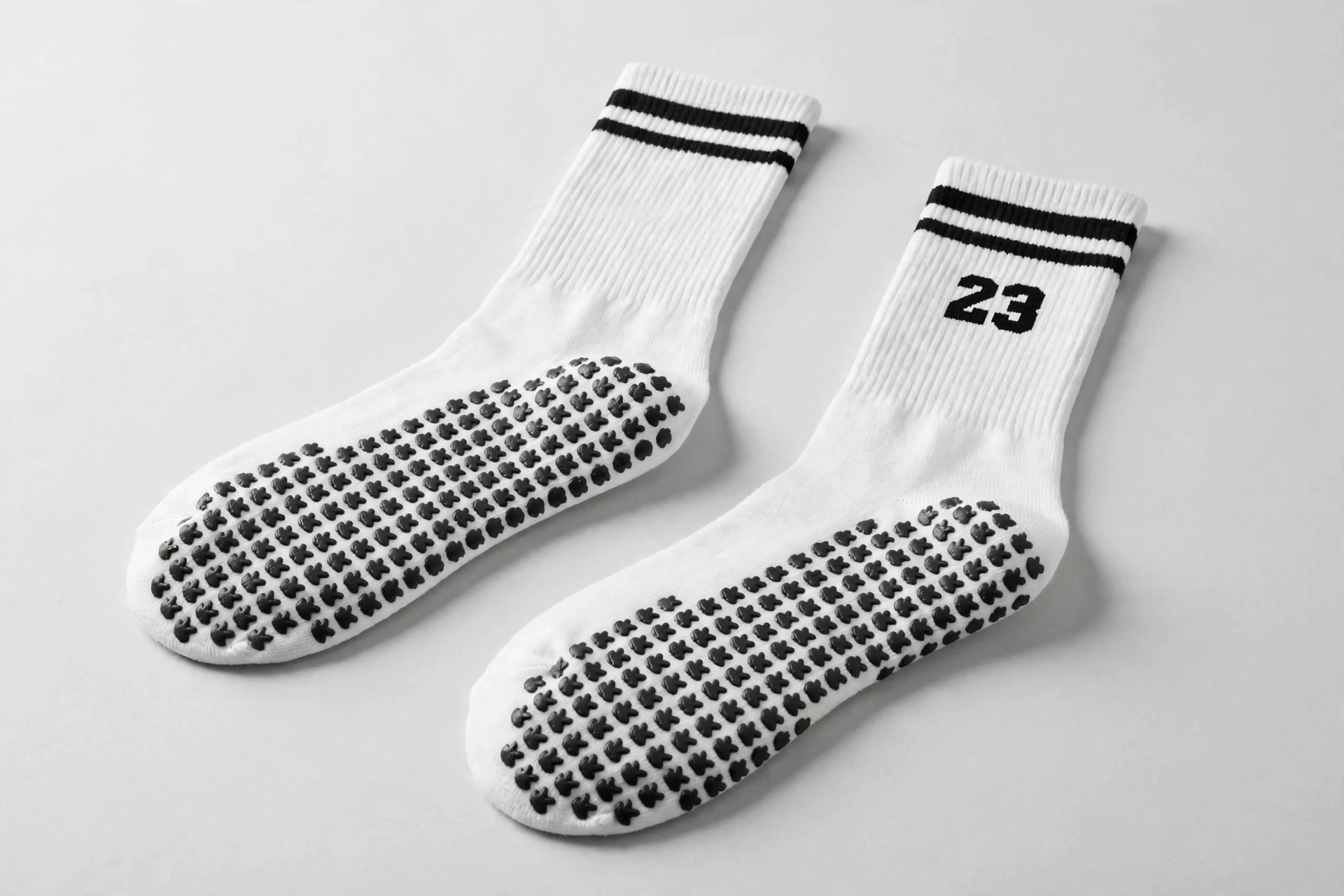 White 23 crew socks with black double stripes showing black rubberized grip dots high-traction on sole - specialized non-slip grip socks for indoor training yoga stability 1536x1024